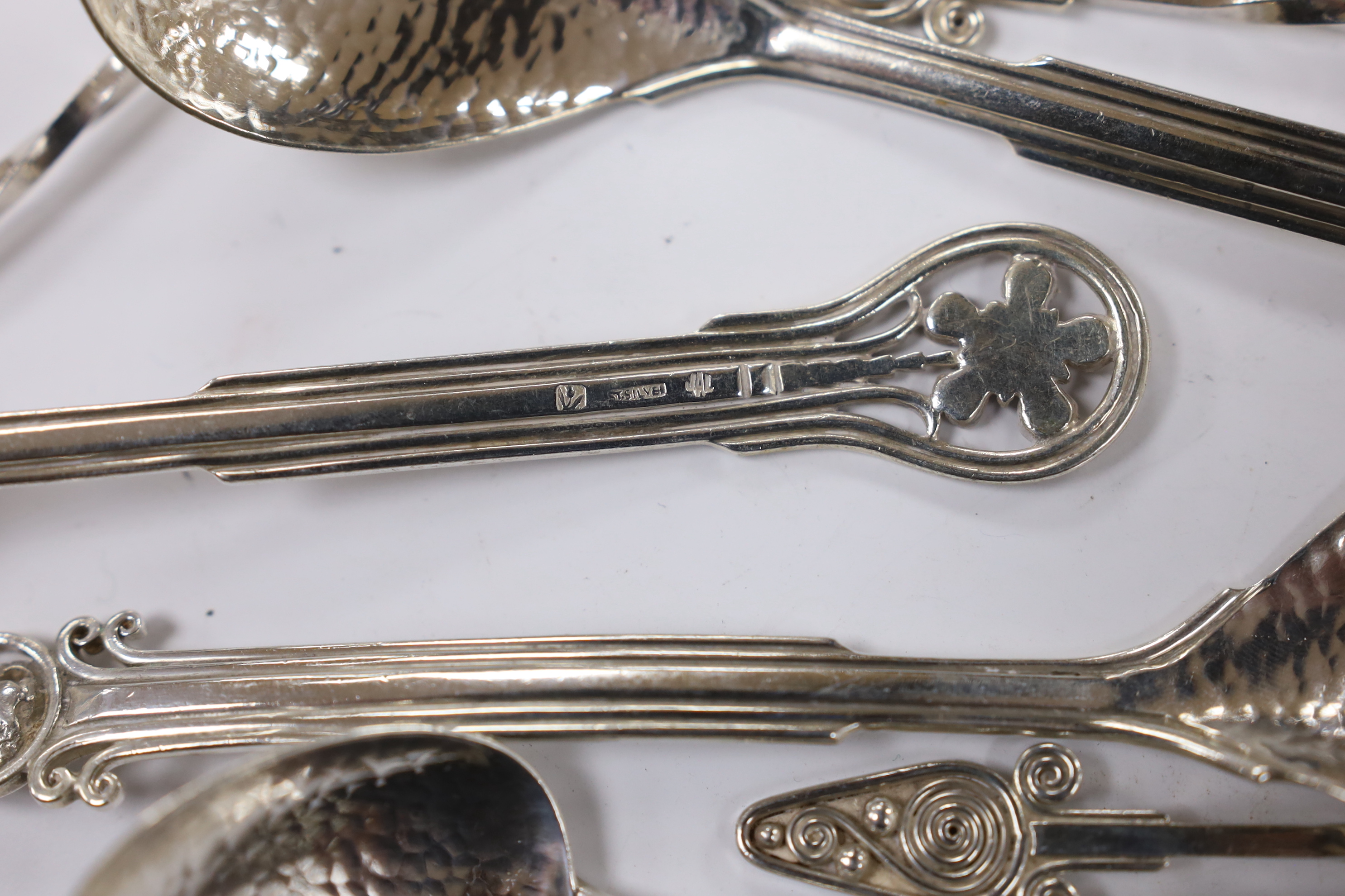 Seven Australian Arts & Crafts sterling spoons, by James A. Linton, with planished bowls and differing terminals, largest 15.2cm, together with a set of six Australian Arts & Crafts sterling small spoons, one with maker'